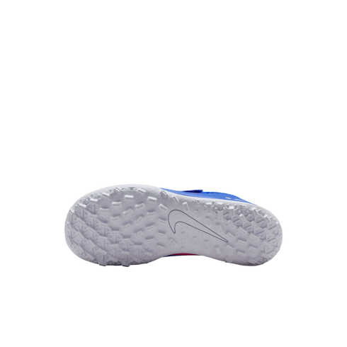 The bottom view of a white Nike turf shoe sole, featuring a dense pattern of small rectangular studs and a grey swoosh logo, set against a black background.