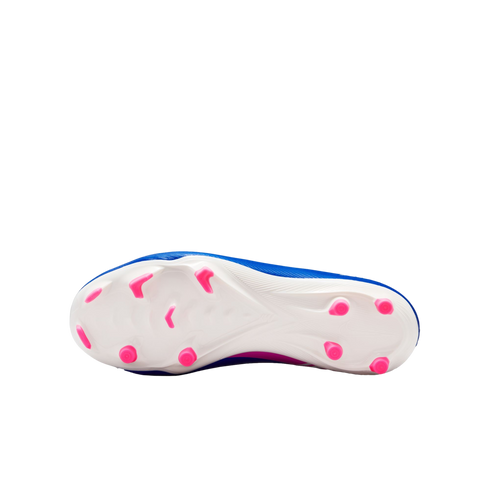 Underside of a blue soccer cleat with a white soleplate and bright pink studs against a black background.