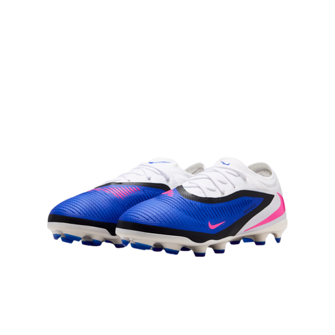 A pair of blue and white Nike soccer cleats with pink accents and black trim on a black background.