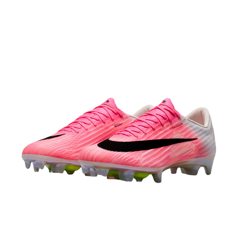 A pair of pink and white Nike soccer cleats with a black swoosh and iridescent soleplate, shown against a white background.