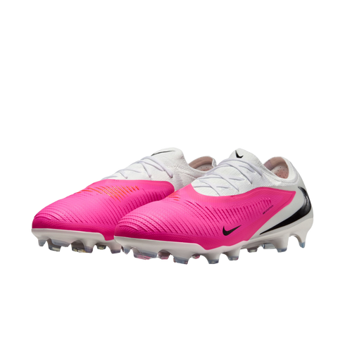 A pair of vibrant pink and white Nike soccer cleats with black swooshes and white studded soles, shown against a white background.