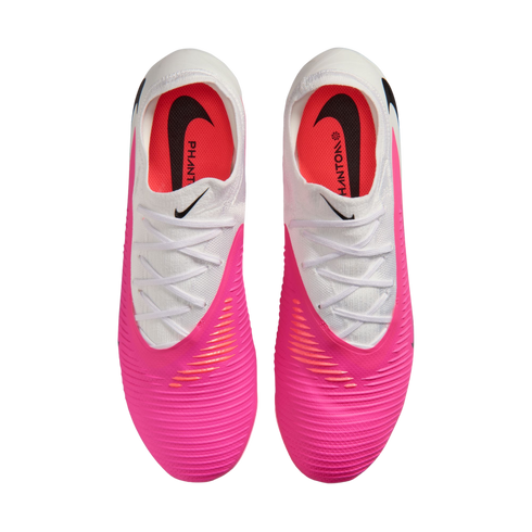 Top-down view of pink and white Nike Phantom soccer cleats on a white background.