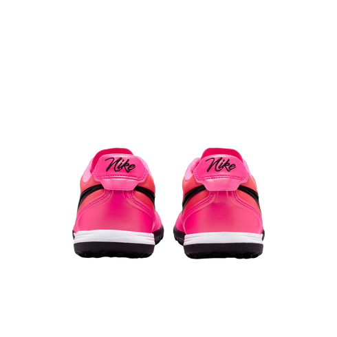 Rear view of two bright pink Nike sneakers with black script logos on the heels, white midsoles, and black outsoles against a plain white background.