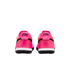 Rear view of two bright pink Nike sneakers with black script logos on the heels, white midsoles, and black outsoles against a plain white background.
