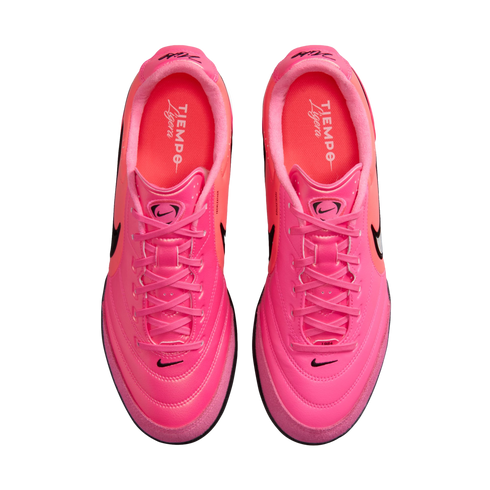 A top-down view of a pair of vibrant pink Nike Tiempo Ligera sneakers with matching pink laces and black branding on a white background.