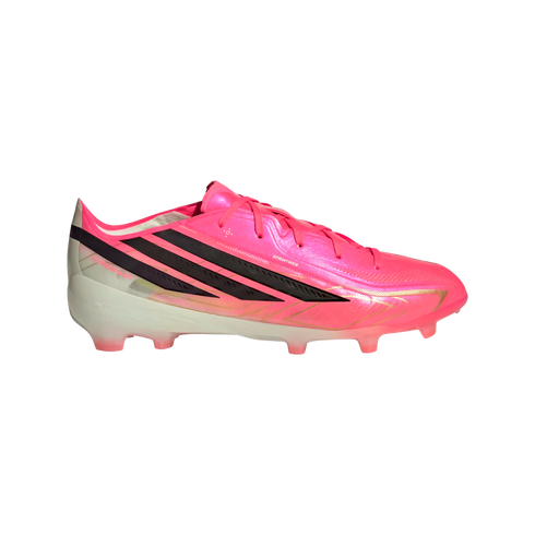 Side profile of a vibrant pink Adidas soccer cleat with three black stripes, gold accents, and a translucent white studded sole.