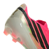Close-up of the heel of a pink and white Adidas soccer cleat with black stripes, a gold FIFA logo, and translucent pink studs.