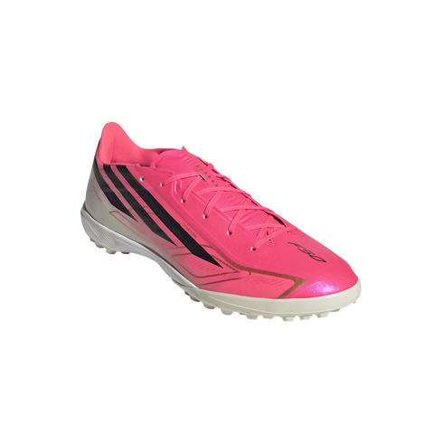 Bright pink Adidas F50 turf soccer shoe featuring black stripes and gold accents with a white studded sole.