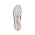 Underside of a white Adidas Predator soccer shoe showing a multi-studded turf outsole with gold plates and pink accents.