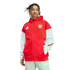 A man with dreadlocks wearing a red and white Adidas Arsenal zip-up hoodie and light-colored pants, posed against a white background.