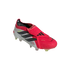 A pink and white Adidas Predator soccer cleat with black stripes and a fold-over tongue, displayed against a solid black background.
