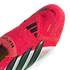 Close-up of a red Adidas Predator soccer cleat with black stripes, white side accents, and the text "EST. 1994" and "NANOSTRIKE+".