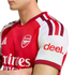Man wearing a red and white Arsenal FC home jersey with visible club crest and "deel." sleeve sponsor.