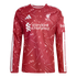 A red long-sleeve Liverpool FC training top with white geometric patterns, Adidas logo, club crest, and Standard Chartered sponsor logo.