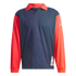 A long-sleeved polo shirt with a navy blue body and contrasting bright red sleeves and collar. The shirt features a World Cup USA 94 patch on the lower front corner and a blue Adidas logo on the upper left sleeve.