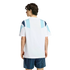 Back view of a man in a white t-shirt with blue geometric shoulder patterns and navy striped shorts against a white background.