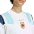 Close-up of a white Adidas sweatshirt featuring light blue shoulder panels and a gold embroidered Argentina Football Association (AFA) crest on the chest.