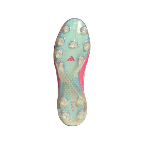 Bottom view of an iridescent light blue and pink Adidas Copa football boot sole with transparent conical studs.