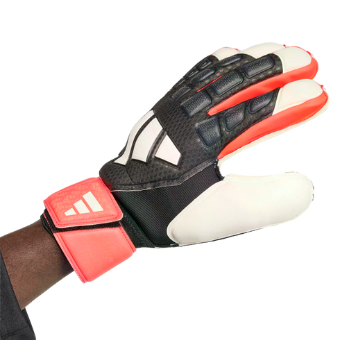 An Adidas goalkeeper glove with a black, white, and red textured design, worn on a hand against a white background.