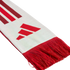 Close-up of a white knitted scarf with red fringe, featuring the red Adidas three-bar logo and diagonal red and maroon stripes.