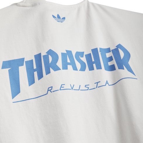 White t-shirt featuring light blue Adidas logo, large arched 'THRASHER' text, and 'REVISTA' in stylized blue script underneath.