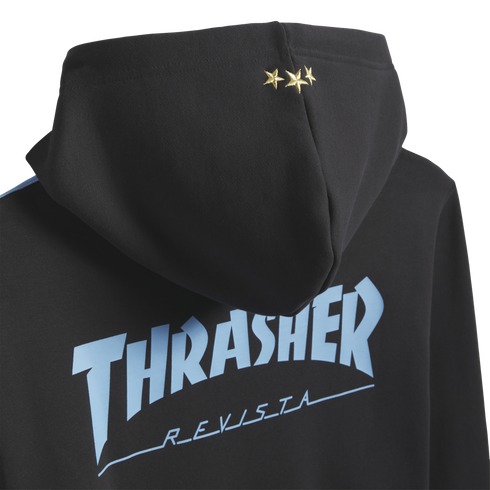 Back of a black hoodie with three gold stars on the hood and light blue "THRASHER REVISTA" text across the back.