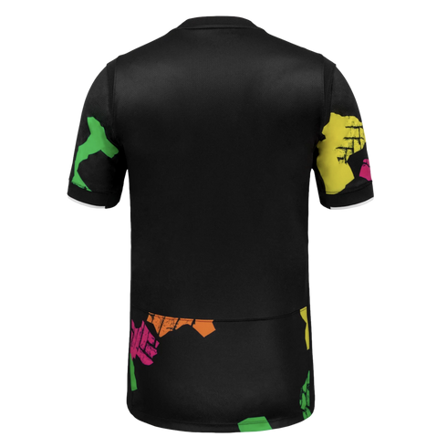 Back view of a black short-sleeved t-shirt with colorful, distressed abstract patterns on the sleeves and lower hem. Sleeve cuffs feature a white trim.