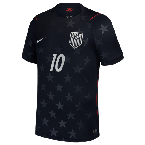 A black USA national team soccer jersey featuring a subtle all-over tonal star pattern. The jersey has a white Nike swoosh on the right chest, the USA national team crest on the left, and a white number 10 in the center. Thin red accents are visible along