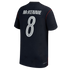 The back view of a navy blue soccer jersey featuring the name "MCKENNIE" and the number "8" in large white lettering. The jersey has a subtle tonal star pattern across the fabric and thin red piping along the shoulder and side seams.