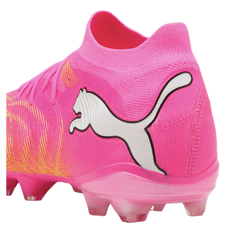 Bright pink Puma soccer cleat with a large white cat logo, pink knitted upper, and matching pink studded sole.