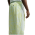 Rear view of a person wearing light green patterned athletic pants featuring white mesh side panels, an elastic waistband, and a small zippered back pocket.
